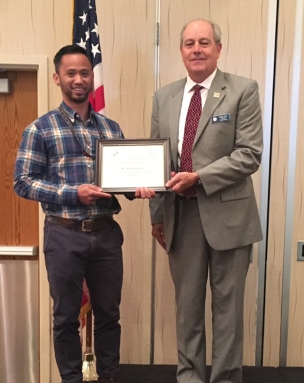 Sims presents the Civilian Cyber Professional Award to Alan Balisacan during the June luncheon.